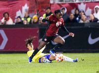 Canada's Deanne Rose gets past Brazil's  Lauren during second half soccer action in Halifax, N.S., on Tuesday, October 31, 2023. THE CANADIAN PRESS/Ron Ward