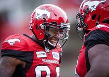 Calgary Stampeders' Kamar Jorden, left, celebrates his touchdown with a teammate during first quarter CFL football action against the Montreal Alouettes, in Calgary, Saturday, July 21, 2018. Jorden won't be hitting the CFL free-agent market. The Calgary Stampeders re-signed the all-star receiver to a two-year deal Friday. Jorden was eligible to become a free agent next month. THE CANADIAN PRESS/Jeff McIntosh