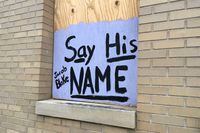 A sign in support of Jacob Blake is displayed on a boarded up window in Kenosha, Wis., on Jan. 7. 2021.
