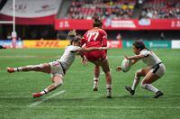 Canada's Chloe Daniels, centre, collides with United States' Kayla Canett, left, and Alena Olsen during HSBC Canada Sevens women's rugby action, in Vancouver, on Friday, March 3, 2023. THE CANADIAN PRESS/Darryl Dyck