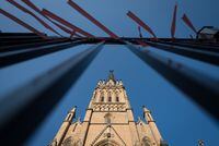 Orange ribbons - a memorial symbol for the 215 Indigenous children who's remains were found at a former Kamloops Indian Residential School - are tied to the gates surrounding St. Michael's Cathedral Basilica in Toronto, Ont., on Thursday, August 5, 2021.  Tijana Martin/ The Globe and Mail