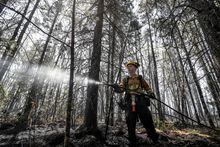 Firefighter Kalen MacMullin of Sydney, Nova Scotia, Canada works at the Barrington Wildfire Complex in the province, in this social media handout image released June 1, 2023.