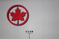 The Air Canada logo is seen on a hangar at Vancouver International Airport, in Richmond, B.C., on Friday, March 20, 2020. Air Canada says it has converted options for 15 Airbus A220-300 aircraft into firm orders. THE CANADIAN PRESS/Darryl Dyck