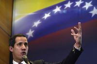 FILE - Opposition leader Juan Guaido explains the income and expenses of his self-proclaimed, parallel government in Caracas, Venezuela, Sept. 16, 2022. Guaido declared himself Venezuela’s interim president in January 2019, arguing that in his capacity as then-president of the country’s National Assembly the constitution allowed him to form a transitional government because Nicolas Maduro had been re-elected in a sham vote in late 2018. Dozens of countries, including the U.S., Canada and Colombia, supported Guaido’s move and began recognizing him as Venezuela’s legitimate leader. (AP Photo/Ariana Cubillos, File)