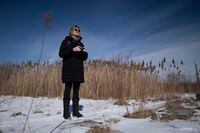 Diane Gibbs, who is new to the bird watching hobby scans with her eyes and binoculars during an outing in Toronto, Ontario on February 28, 2022. (Photo by Peter Power for The Globe and Mail)