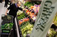 A shopper looks through the produce section in a newly opened Walmart Neighborhood Market in Chicago, in this September 21, 2011, file photo.  Wal-Mart Stores Inc said on June 3, 2013, it is offering a money-back guarantee on the fruits and vegetables it sells at its Walmart U.S. stores as it tries to gain more ground in the grocery business.REUTERS/Jim Young/Files   (UNITED STATES - Tags: FOOD BUSINESS)