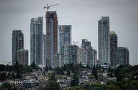 An aircraft passes behind towers in the Metrotown area of Burnaby, B.C., on Sunday, May 30, 2021.The British Columbia government has set the allowable rent increase for next year at 3.5 per cent.THE CANADIAN PRESS/Darryl Dyck