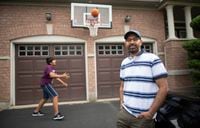 Balwinder Bal and his 12 year old son Arshveer (playing basketball in the driveway) are photographed at Brampton, Ont home, in the L6P postal code area, on June 29, 2021. Arshveer spent the past year doing online learning and both are hoping schools will be safe enough for in class learning in Sept. Fred Lum/The Globe and Mail.  
