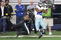 Dallas Cowboys' T.Y. Hilton makes a long ctch in front of Philadelphia Eagles' Reed Blankenship during the second half of an NFL football game Saturday, Dec. 24, 2022, in Arlington, Texas. (AP Photo/Tony Gutierrez)