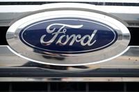 The Ford logo shines off the grille of a vehicle at a Ford dealership in Littleton, Colo., Oct. 20, 2019. Ford Motor Co. says it will recall about 8,800 vehicles in Canada after the automaker lost track of some older Takata air bags that can explode and hurl shrapnel. THE CANADIAN PRESS/AP-David Zalubowski