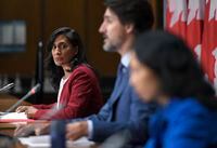 Minister of Public Services and Procurement Anita Anand listens to Prime Minister Justin Trudeau speak during a news conference on the COVID-19 pandemic on Parliament Hill in Ottawa, on Friday, Sept. 25, 2020. THE CANADIAN PRESS/Justin Tang