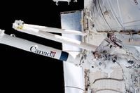 STS100-396-007 (19 April -1 May 2001) --- Astronaut Scott E. Parazynski, mission specialist, works with cables associated with the Space Station Remote Manipulator System (SSRMS) or Canadarm2 during one of two days of extravehicular activity (EVA). Parazynski shared both space walks with astronaut Chirs A. Hadfield of the Canadian Space Agency (CSA).