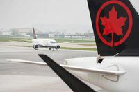 An Air Canada flight taxies on the tarmac at Pierre Elliott Trudeau International Airport in Montreal, Quebec, on May 16, 2022. (Photo by Geoff Robins / AFP) (Photo by GEOFF ROBINS/AFP via Getty Images)