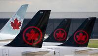 Air Canada logos are seen on the tails of planes at the airport in Montreal on Monday, June 26, 2023. Air Canada reported a profit of $1.25 billion in its latest quarter compared with a loss of $508 million in the same quarter last year. THE CANADIAN PRESS/Adrian Wyld