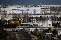 Abandoned transport trucks are seen on the Trans-Canada Highway in a flooded area of Abbotsford, British Columbia, on Tuesday, Nov. 16, 2021. (Darryl Dyck/The Canadian Press via AP)