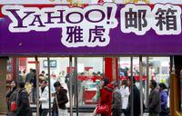 (FILES) In this file photo taken on November 14, 2007, pedestrians walk past a Yahoo billboard in Beijing. - US internet services giant Yahoo pulled out of mainland China starting on November 1, 2021, the company said in a statement on its website, amid an ongoing crackdown by Beijing on the tech industry. (Photo by TEH ENG KOON / AFP) (Photo by TEH ENG KOON/AFP via Getty Images)