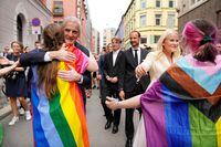 Norway's Crown Prince Haakon, Crown Princess Mette-Marit and Norway's Prime Minister Jonas Gahr Stoere greet people as they visit a scene of a shooting at the London Pub, a popular gay bar and nightclub, in Oslo, Norway, June 25, 2022. Javad Parsa/NTB/via REUTERS