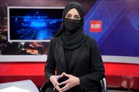 TV anchor Khatereh Ahmadi wears a face covering as she reads the news on TOLO NEWS, in Kabul, Afghanistan, Sunday, May 22, 2022. Afghanistan's Taliban rulers have begun enforcing an order requiring all female TV news anchors in the country to cover their faces while on-air. The move Sunday is part of a hard-line shift drawing condemnation from rights activists. (AP Photo/Ebrahim Noroozi)