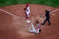 Oct 7, 2022; St. Louis, Missouri, USA; Philadelphia Phillies pinch runner Edmundo Sosa (33) reacts after slides safely past St. Louis Cardinals catcher Yadier Molina (4) in the ninth inning during game one of the Wild Card series for the 2022 MLB Playoffs at Busch Stadium. Mandatory Credit: Jeff Curry-USA TODAY Sports