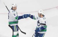 Vancouver Canucks' Brock Boeser, left, and J.T. Miller celebrate a goal during their 5-2 win over the St. Louis Blues in Edmonton on Aug. 12, 2020. The Canucks lead the series 1-0.