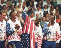 FILE PHOTO: U.S. basketball player Michael Jordan (2nd R) flashes a victory sign as he stands with team mates Larry Bird (L), Scottie Pippen and Clyde Drexler (R), nicknamed the "Dream Team" after winning the Olympic gold in Barcelona, Spain on August 8, 1992.   REUTERS/Ray Stubblebine/File Photo