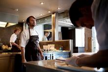 FILE-- Rene Redzepi, center, chef of Noma who practices a earthly style of cooking known as "new Nordic," works in the kitchen at the restaurant in Copenhagen, June 21, 2010. Noma will become a full-time food laboratory, developing new dishes and products for its e-commerce operation, Noma Projects, and the dining rooms will be open only for periodic pop-ups. (Erik Refner/The New York Times)