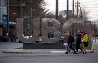 People walk past large letters spelling out UBC at the University of British Columbia in Vancouver on Nov. 22, 2015.
