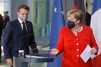 German Chancellor Angela Merkel, right, and French President Emmanuel Macron give a joint statement to journalists, at the chancellery in Berlin, Germany, Friday June 18, 2021. (Axel Schmidt/Pool via AP)