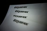 Equifax logos are shown on paper in Toronto on Oct.17, 2019. Equifax Canada says credit card balances reached an all-time high of $107.4 billion in the second quarter of 2023. THE CANADIAN PRESS/Christopher Katsarov