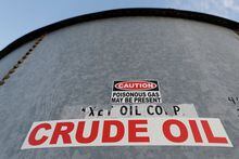 FILE PHOTO: A sticker reads crude oil on the side of a storage tank in the Permian Basin in Mentone, Loving County, Texas, U.S. November 22, 2019.  REUTERS/Angus Mordant