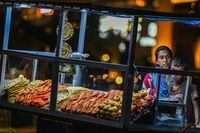A street vendor sells prawns and sea-food at her kiosk at the Galle Face Beach in Colombo on March 20, 2023. - Cash-strapped Sri Lanka is seeking a 10-year moratorium on its foreign debt, President Ranil Wickremesinghe's office said on March 20 on the eve of a desperately needed $2.9 billion IMF bailout. (Photo by ISHARA S. KODIKARA / AFP) (Photo by ISHARA S. KODIKARA/AFP via Getty Images)