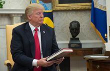 (FILES) In this file photo taken on February 02, 2018 US President Donald Trump looks at a book given to him by a North Korean defector in the Oval Office at the White House in Washington, DC. - Donald Trump is releasing more than 150 letters from giants of world history such as Richard Nixon, Kim Jong Un and Oprah Winfrey, the former US president and his publisher said March 9, 2023. (Photo by Andrew CABALLERO-REYNOLDS / AFP) (Photo by ANDREW CABALLERO-REYNOLDS/AFP via Getty Images)