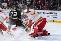 Arizona Coyotes' Travis Boyd (72) slaps the puck past Calgary Flames goalie Jacob Markstrom (25) for an overtime goal iln an NHL hockey game Tuesday, March 14, 2023, in Tempe, Ariz. (AP Photo/Darryl Webb)