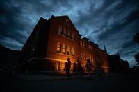 A growing number of Canadian corporations are pursuing cultural awareness training in order to get better at recruiting and retaining Indigenous employees. People are silhouetted as they walk past the former Kamloops Indian Residential School in Kamloops, B.C., on Monday, May 31, 2021. THE CANADIAN PRESS/Darryl Dyck