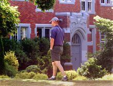 A pedestrian strolls past Vancouver College Thursday July 25, 2002.  An out-of-court settlement will allow Vancouver College and St. Thomas More Collegiate to pay $19-million to liquidators working on compensation for Mount Cashel victims.(CP PHOTO/Chuck Stoody)