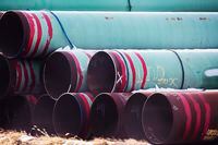 In this Dec. 18, 2020, file photo, pipes to be used for the Keystone XL pipeline are stored in a field near Dorchester, Neb.