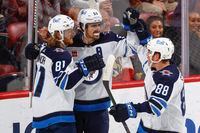 SUNRISE, FL - MARCH 11: Mark Scheifele #55 celebrates his overtime game winning goal with Kyle Connor #81 and Nate Schmidt #88 of the Winnipeg Jets against the Florida Panthers at the FLA Live Arena on March 11, 2023 in Sunrise, Florida. (Photo by Joel Auerbach/Getty Images)