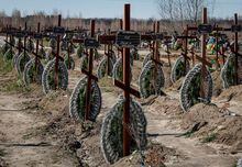 FILE PHOTO: Graves of unidentified people killed by Russian soldiers during occupation of the Bucha town, are seen at the town's cemetery before the first anniversary of its liberation, amid Russia's attack on Ukraine, in the town of Bucha, outside Kyiv, Ukraine March 30, 2023. REUTERS/Gleb Garanich/File Photo