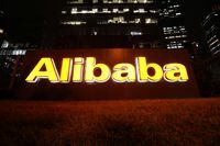 The logo of Alibaba Group is lit up at its office building in Beijing, China August 9, 2021. REUTERS/Tingshu Wang