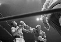FILE - Challenger Earnie Shavers, right, follows through with a right against champion Muhammad Ali during the fourth round of their boxing bout in New York's Madison Square Garden, Sept. 29, 1977. Shavers, whose thunderous punches stopped 68 fighters and earned him heavyweight title fights with Ali and Larry Holmes,  died Thursday, Sept. 1, 2022. He was 78. (AP Photo/Ron Frehm, File)