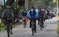 Commuters wearing masks as a precaution amid the spread of COVID-19 ride their bicycles in the Miraflores area of Lima, Peru, Friday, July 10, 2020. More people in Peru's capital city, one of the cities with the highest incidence of contagion and death from the virus, are cycling as a method of transportation as a preventative measure to avoid the new coronavirus. (AP Photo/Martin Mejia)