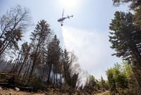 A helicopter drops water on a hot spot at a wildfire in Tantallon, N.S. in this Thursday, June 1, 2023 handout photo. THE CANADIAN PRESS/HO, Communications Nova Scotia *MANDATORY CREDIT*