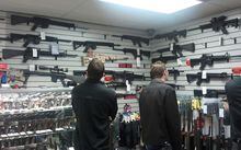 FILE PHOTO: Customers view semi automatic guns on display at a gun shop in Los Angeles, California December 19, 2012. Gun shops report increase in sales since the Connecticut school massacre.      REUTERS/Gene Blevins/File Photo
