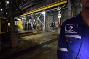 Cameco Corp. reported a loss in its latest quarter as it was hit by charges related to its acquisition of a stake in Westinghouse Electric Co., one of the world's largest nuclear services businesses. A Cameco employee is shown during a media tour of the uranium mine in Cigar Lake, Sask. on Wednesday, Sept. 23, 2015. THE CANADIAN PRESS/Liam Richards