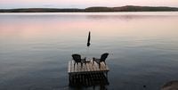 Muskoka chairs sit on a dock looking over Boshkung Lake, in Algonquin Highlands, Ont., Monday, Oct. 5, 2020. AirBnB CEO Brian Chesky says he's expecting more domestic travel to cottage country and other rural retreats amid the COVID-19 pandemic. THE CANADIAN PRESS/Giordano Ciampini