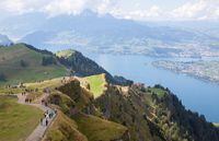 FILE PHOTO: Tourists walk as Lake Lucerne is seen in the background, near the peak of Mount Rigi, Switzerland September 4, 2022. REUTERS/Arnd Wiegmann/File Photo