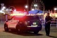 This image made from video provided by KVII shows a police officer stands beside a police car near a shooting scene in Amarillo, Texas Monday, Sept. 19, 2022. A gunman shot a few people, including first responders, at the Tri-State Fair & Rodeo in Texas, before he was shot and wounded by sheriff's deputies, authorities said.(KVII via AP)