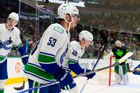 Mar 26, 2022; Dallas, Texas, USA; Vancouver Canucks center Bo Horvat (53) and center Elias Pettersson (40) skate off the ice after scoring against Dallas Stars goaltender Jake Oettinger (29) during the third period at the American Airlines Center. Mandatory Credit: Jerome Miron-USA TODAY Sports