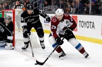 Colorado Avalanche's Nathan MacKinnon is chased by Los Angeles Kings' Ben Hutton (15) during the first period of an NHL hockey game on March 9, 2020, in Los Angeles.