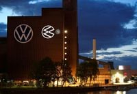 FILE PHOTO: A cartoon of a VW logo squashing the coronavirus is displayed on a building at Volkswagen's headquarters to celebrate the plant's re-opening during the spread of the coronavirus disease (COVID-19) in Wolfsburg, Germany April 25, 2020. REUTERS/Fabian Bimmer/File Photo